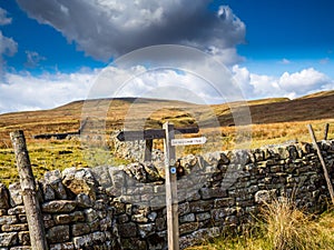 Signpost on stone wall in Yorkshire Dales