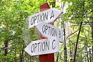 Signpost with three arrows - option A, B, C