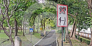 Signposts alerting people to social distancing in the park