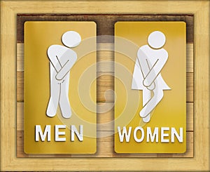 Signs female and male bathroom on wooden background.