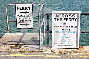 Signs for ferry and cruise trips to Portland at Weymouth Harbor