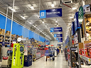 The signs hanging from the ceiling at Lowes home improvement store that designate what departments are in the aisle while people