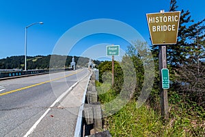 Signs and obelisks on the south end of the Rogue River Bridge at Gold Beach, Oregon, USA