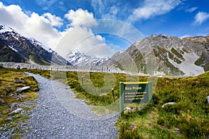 High rocky mountains and green grass in summer in New Zealand