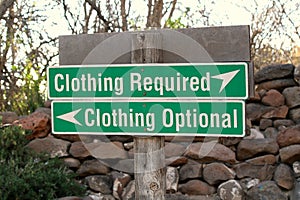 Clothing optional vs clothing required sign at beach.