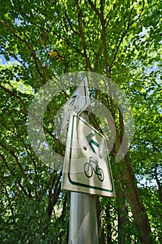 The signs show the way for cyclists in both directions. White sign with green writing. A german traffic sign.