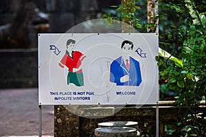 Signs telling visitors of the Ancient buddhist pagoda cave complex Bich Dong to wear long clothes and be polite