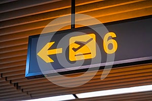 Signs to gate number six for boarding gates inside the airport terminal