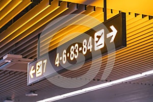 Signs to gate numbers for boarding gates inside the airport terminal