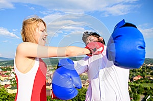 Signs you are henpecked husband. Leadership family relations. Couple boxing gloves fight sky background. Girl confident