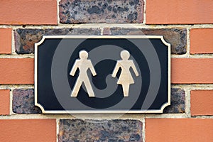 SignShowing Male And Female Figures Outside Public Toilet To Illustrate Gender Issues photo