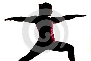 Sihlouette of woman doing yoga exercise called War