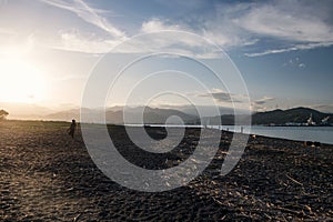 Sihouette poeple walk on Miho beach to fishing at sunset, Shimizu
