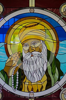 Sikh guru portrait on stained glass in the Sikh temple photo