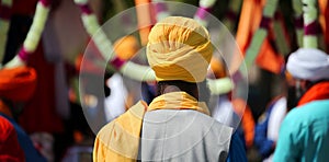 Sikh man with yellow turban during the religious celebration photo