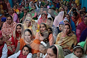 Sikh women and childs inside a temple in Mallorca to celebrate a Sikh festivity