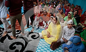 Sikh women and sons inside a temple in Mallorca to celebrate a Sikh festivity