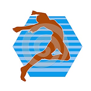 Silhouette of a female ballet dancer in action pose.