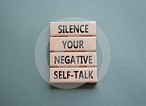 Silence your negative self-talk symbol. Concept words Silence your negative self-talk on wooden blocks. Beautiful grey green