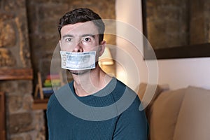 Silenced man with money covering mouth