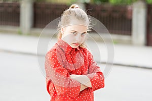 Silent protest. Disagreement and stubbornness. Girl serious face crossed hands on chest. Kid unhappy. Teenage psychology