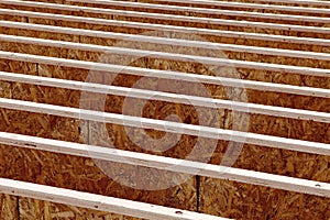 Silent style floor joists, made from engineered wood, in the floor of an office building being constructed.