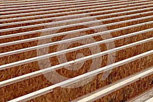 Silent style floor joists, made from engineered wood, in the floor of an office building being constructed.