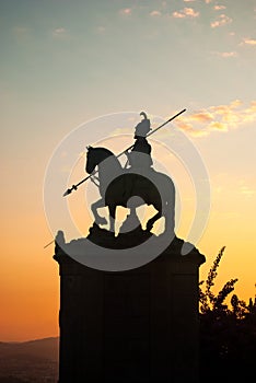 Silhoette of a statue of a soldier with a pike riding a horse against colorful sunset sky - Bom Jesus do Monte, Braga