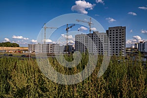 silhoette of tower cranes on construction site, providing housing for low-income citizens of third world countries