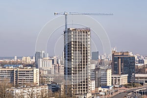 silhoette of tower cranes on construction site, providing housing for low-income citizens of third world countries