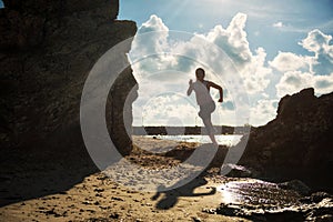 Silhouete female runner at beach