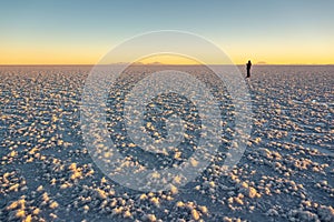 Silhouete of a man in Salar de Uyuni Uyuni salt flats at sunset, Potosi, Bolivia South America photo