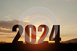 Silhouette 2024 with sunset sky at mountain and number like 2024 abstract background.