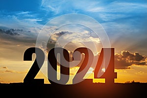 Silhouette 2024 with sunset sky at mountain and number like 2024 abstract background.