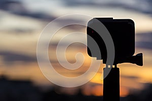 Silhouette Action camera in front of the twilight sky, Technology and Nature concept