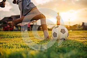 Silhouette action sport outdoors of diversity of kids having fun playing soccer football for exercise in community rural area unde