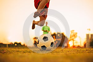 Silhouette action sport outdoors of diversity of kids having fun playing soccer football for exercise in community rural area unde