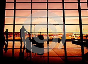 Silhouette of airline passengers in an airport