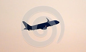 Silhouette of an airplane flying in midair