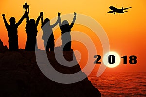 Silhouette airplane with four business people make high hands when business success and trophy receive,2018 new year