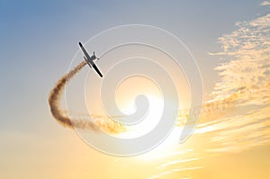 Silhouette of an airplane performing flight at airshow at sundown