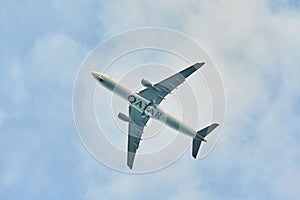Silhouette of an airplane on sky background. Commercial airplane jetliner flying above clouds in beautiful day light. Flight trave