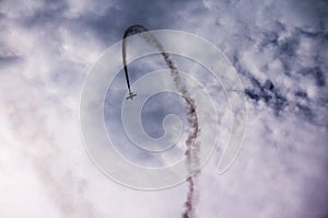 Silhouette of an airplane with smoke;