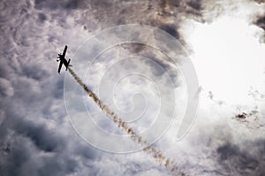 Silhouette of an airplane with smoke;