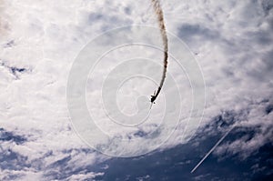 Silhouette of an airplane with smoke;