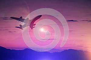 Silhouette of Airplane take off on the Colorful dramatic sky wit