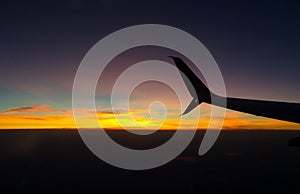Silhouette Airplane wing abstract with sunset or sunrise in the background