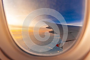 Silhouette of Airplane wing view out of the window the cloudy sunset sky background, Travel and Holiday vacation concept