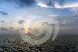 Silhouette of an anchor handling tug boat at oil field during sunrise