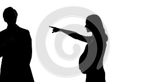 Silhouette of angry pregnant woman quarrelling with husband, hormonal changes